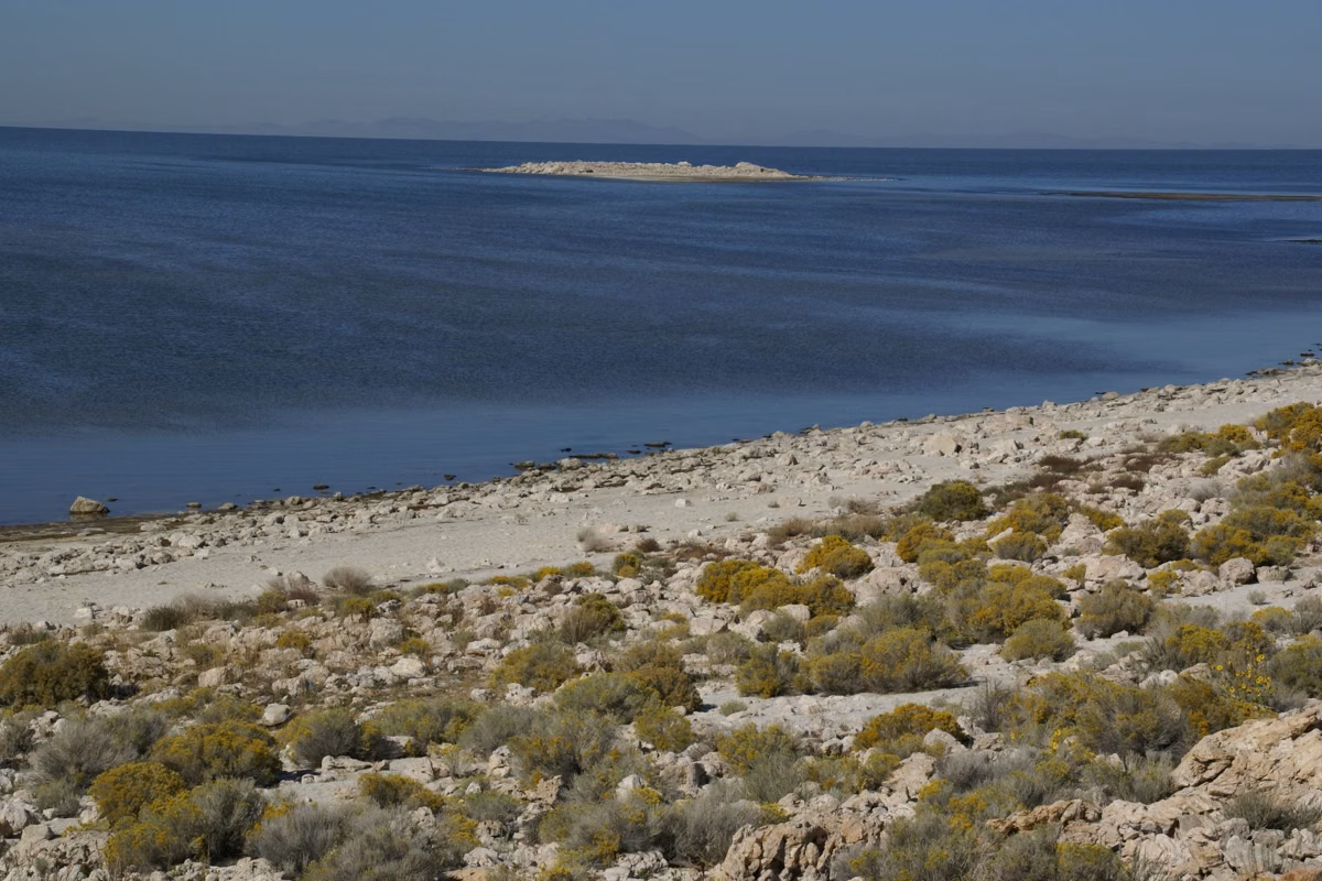 Rocky, shrub-covered slope running down to the Great Salt Lake shoreline on Antelope Island