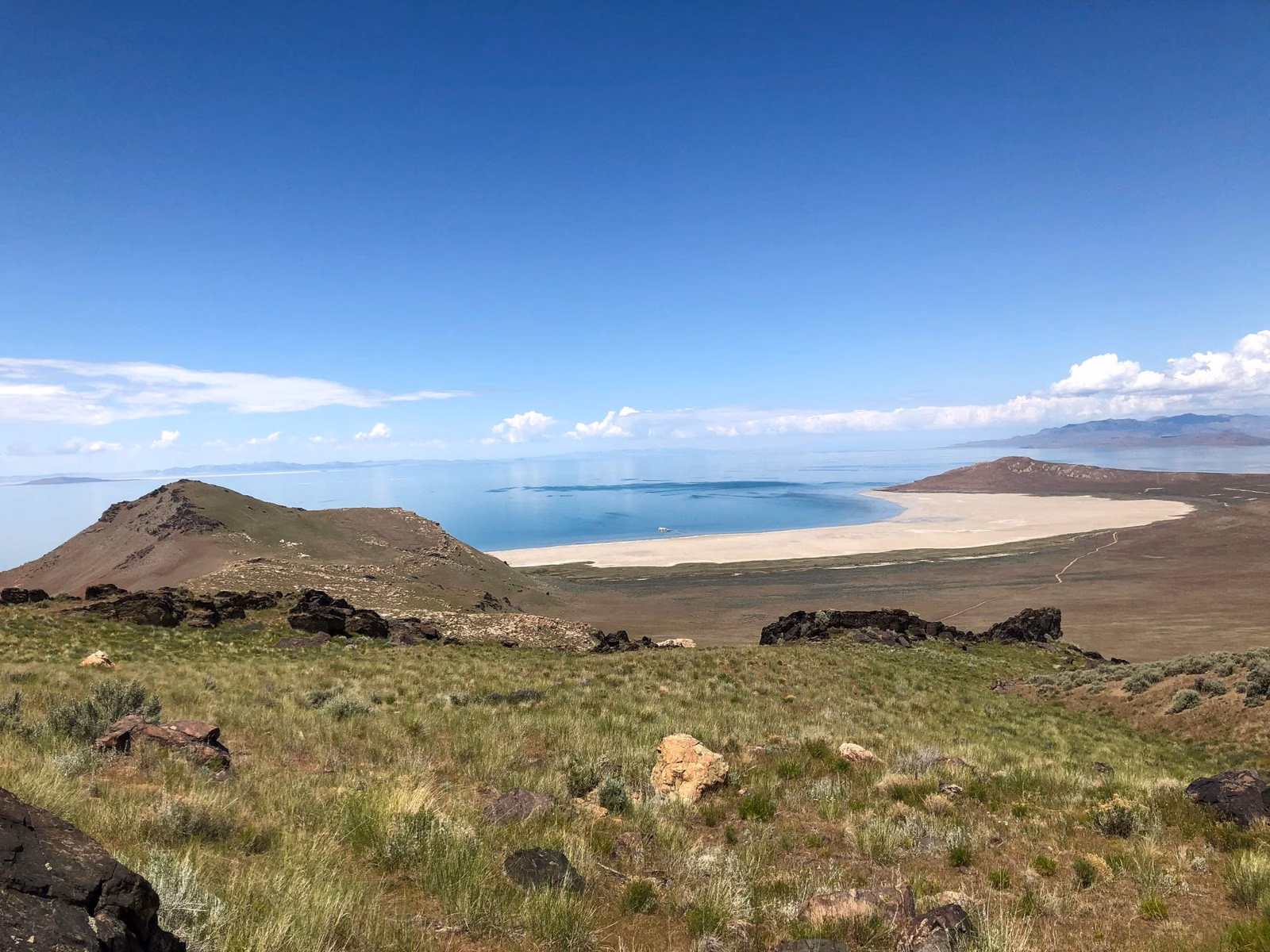 White Rock Bay on the west side of Antelope Island, with green slopes and the turquoise water of Great Salt Lake