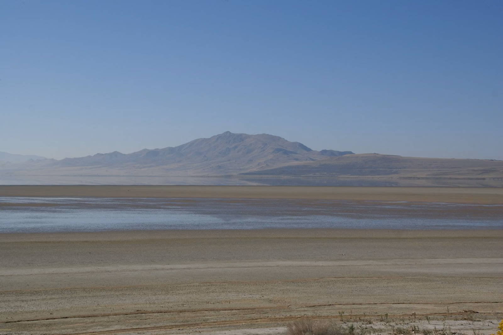 Great Salt Lake seen from the causeway to Antelope Island, with pale mudflats and a distant mountain