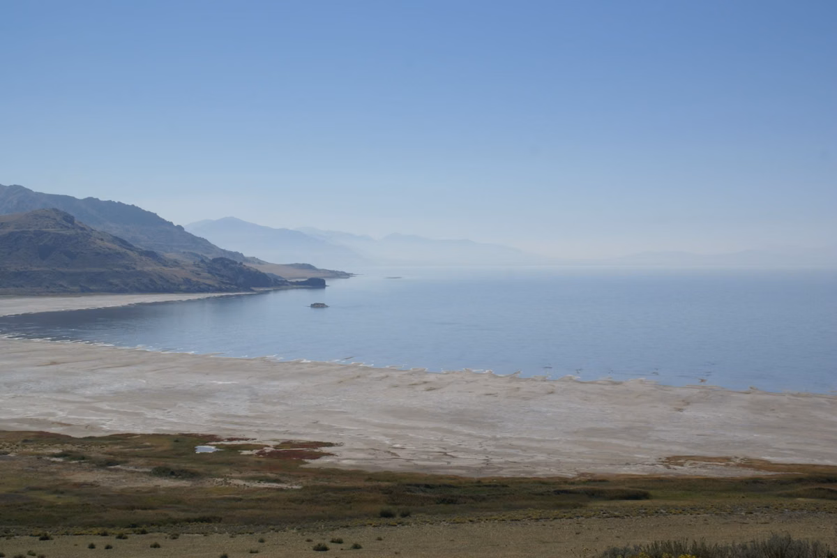 A ridge of Antelope Island running out into Great Salt Lake beyond a pale salt flat