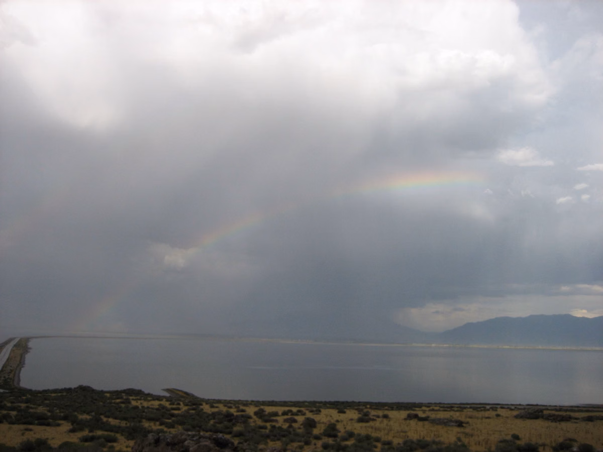 Storm clouds and rain over Great Salt Lake beside the Antelope Island causeway